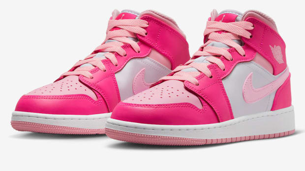 Side view of pink and white Air Jordan shoes.